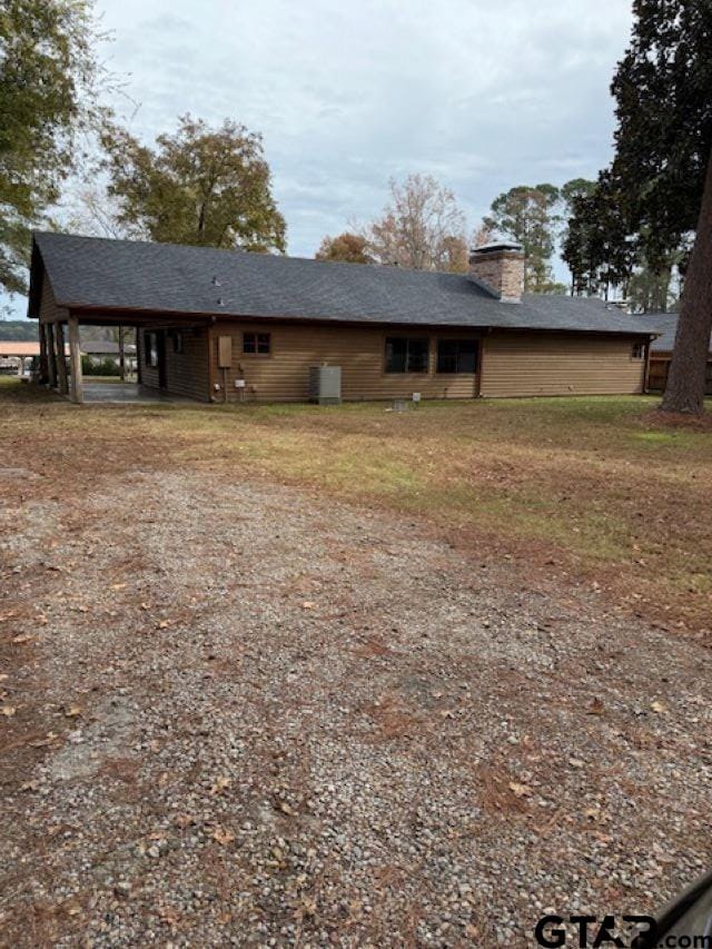 back of property featuring a carport