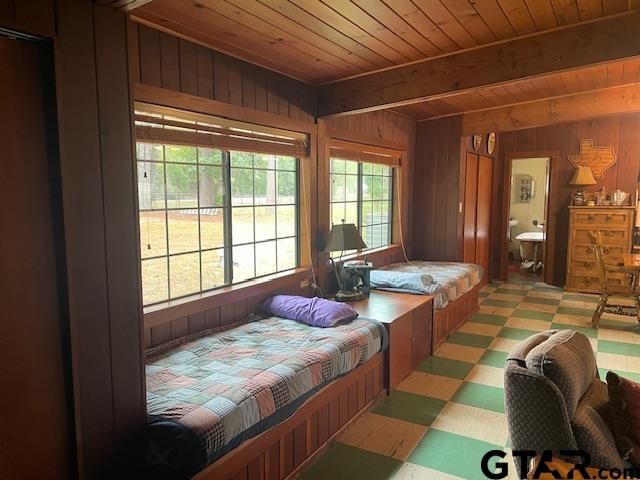 bedroom with wooden walls and wooden ceiling