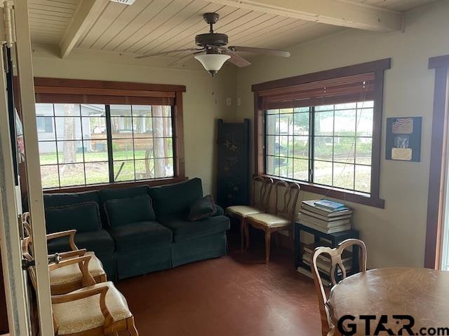 living room with beam ceiling and ceiling fan