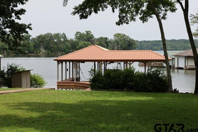 dock area with a yard and a water view