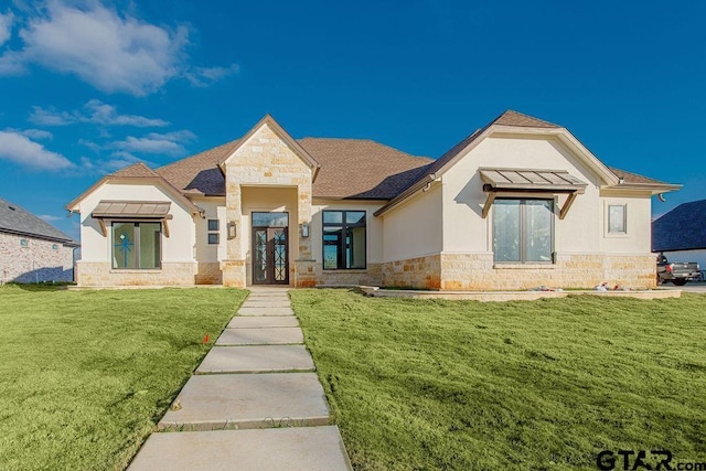 view of front of home featuring a front yard and french doors