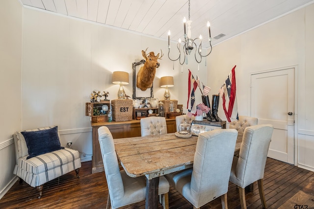 dining space featuring dark hardwood / wood-style flooring, crown molding, wooden ceiling, and an inviting chandelier