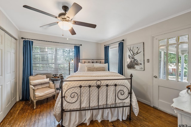 bedroom featuring dark wood-type flooring, ceiling fan, a closet, and crown molding