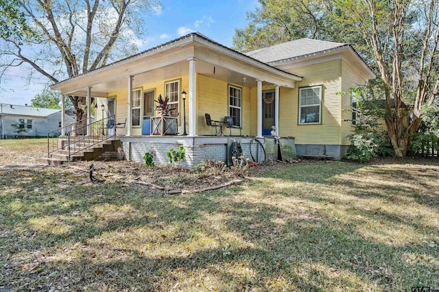 view of front of property with a front yard and a porch