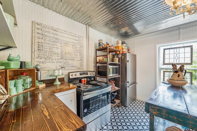 kitchen with butcher block counters and appliances with stainless steel finishes