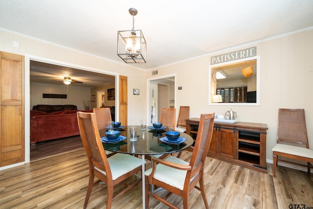 404 W Terrace Dr, Longview, TX 75602 - dining space featuring light wood-style floors, crown molding, and a chandelier