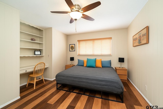 404 W Terrace Dr, Longview, TX 75602 - bedroom with wood finished floors, ceiling fan, and built in desk