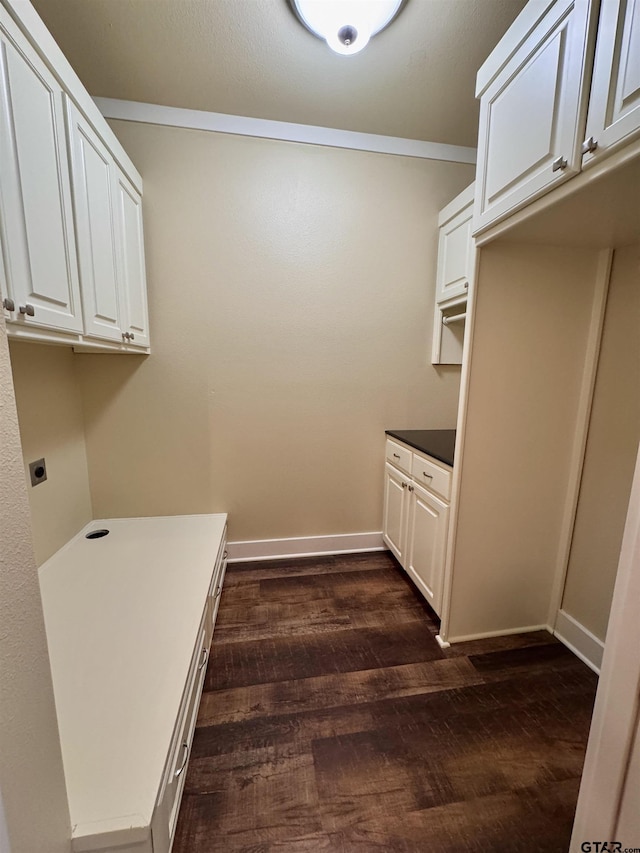 clothes washing area featuring baseboards, cabinet space, dark wood-style flooring, and electric dryer hookup