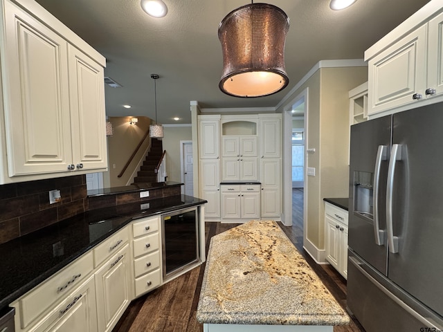 kitchen featuring dark wood-style flooring, light stone countertops, stainless steel fridge with ice dispenser, beverage cooler, and decorative backsplash