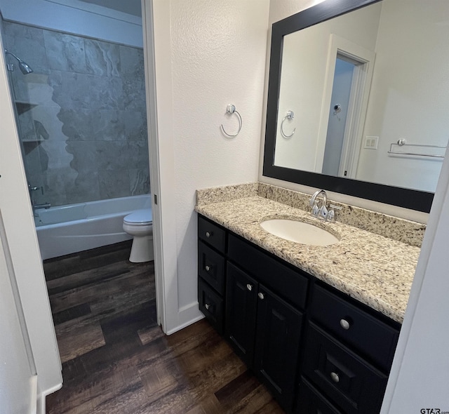 full bathroom featuring vanity, toilet, wood finished floors, and shower / tub combination