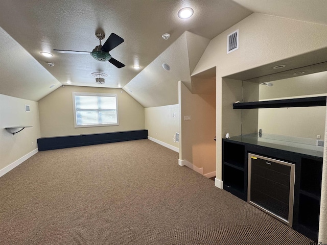 bonus room with carpet floors, a ceiling fan, vaulted ceiling, and visible vents