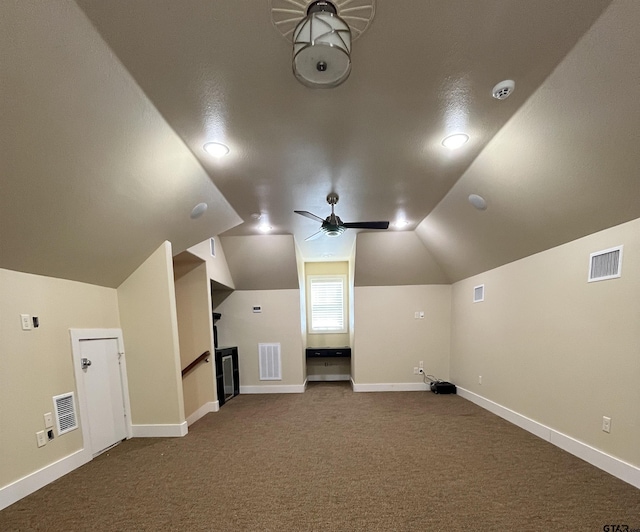 bonus room with visible vents, ceiling fan, dark carpet, and vaulted ceiling