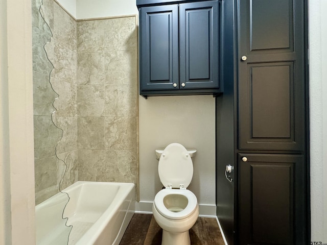 bathroom with toilet, baseboards, and wood finished floors