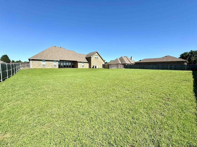 view of yard with a fenced backyard