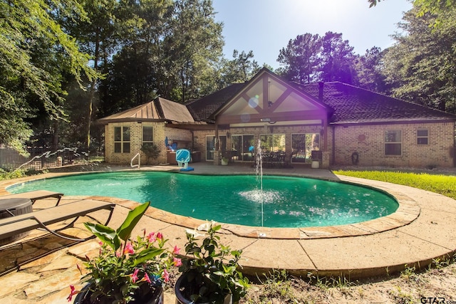 view of pool with pool water feature and a patio