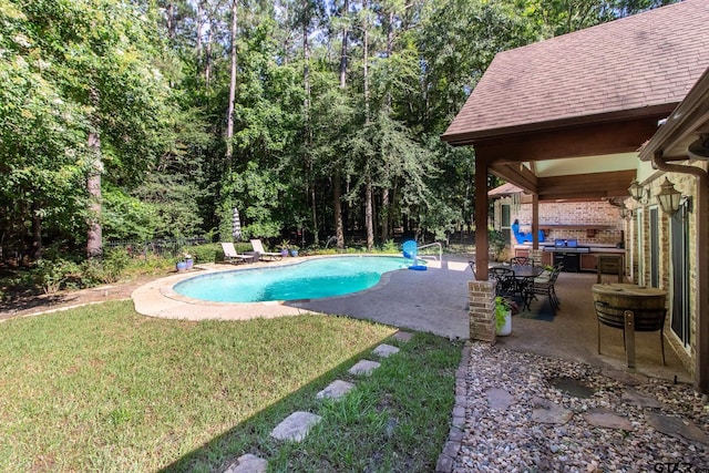 view of swimming pool with a lawn and a patio