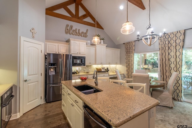 kitchen featuring hanging light fixtures, black appliances, sink, an island with sink, and high vaulted ceiling