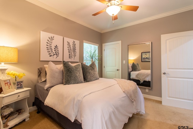 carpeted bedroom with ceiling fan and crown molding