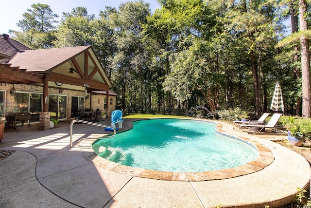 view of pool with a patio and ceiling fan