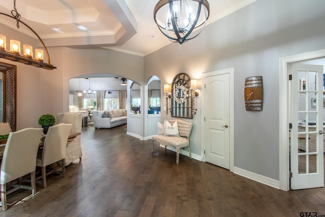 entryway with dark hardwood / wood-style flooring, a tray ceiling, and crown molding