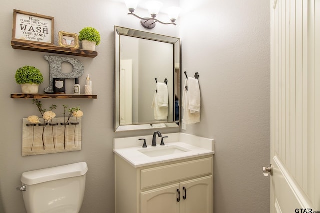 bathroom with vanity and toilet