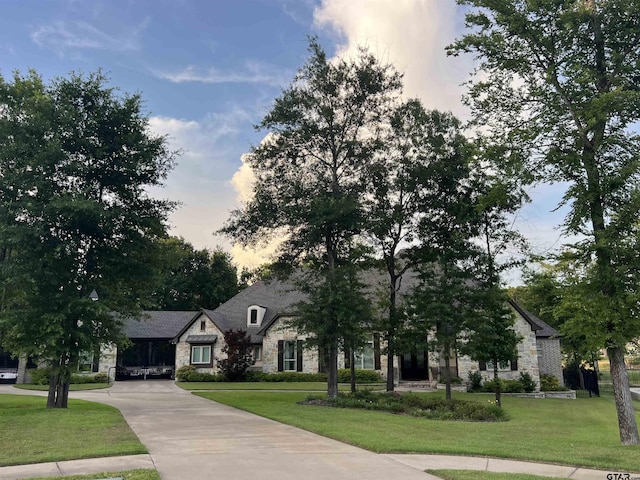 7532 Northlake Dr, Tyler, TX 75703 - french provincial home with stone siding, a front yard, and driveway