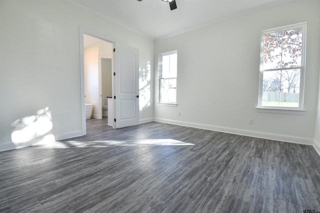 spare room featuring dark hardwood / wood-style flooring, ceiling fan, and ornamental molding