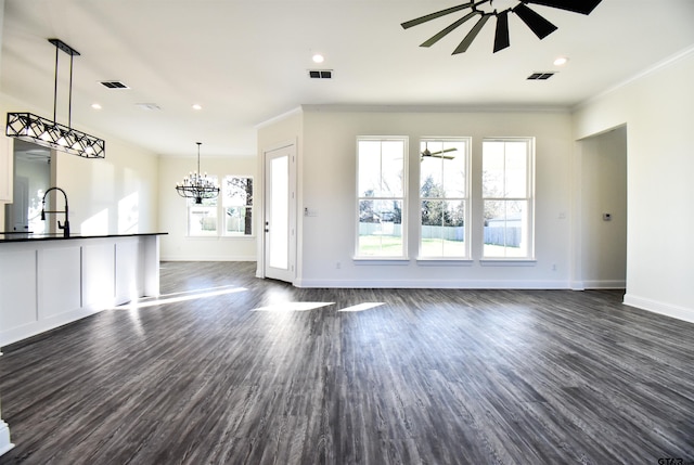 unfurnished living room featuring sink, ceiling fan, crown molding, and dark wood-type flooring