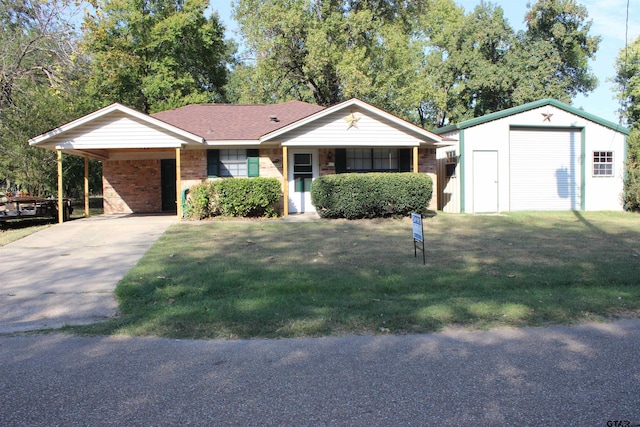 single story home with a carport, a front yard, and an outdoor structure