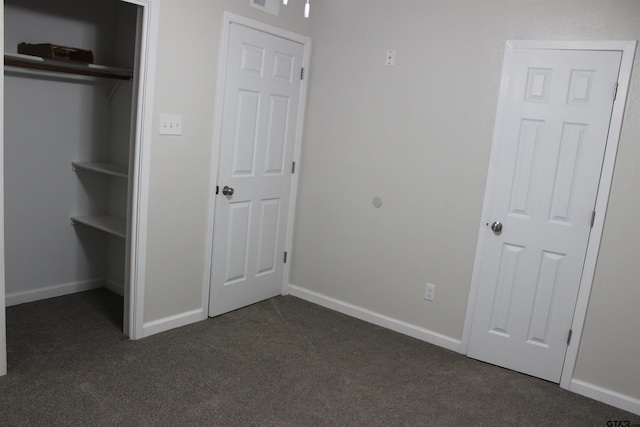 unfurnished bedroom with dark colored carpet