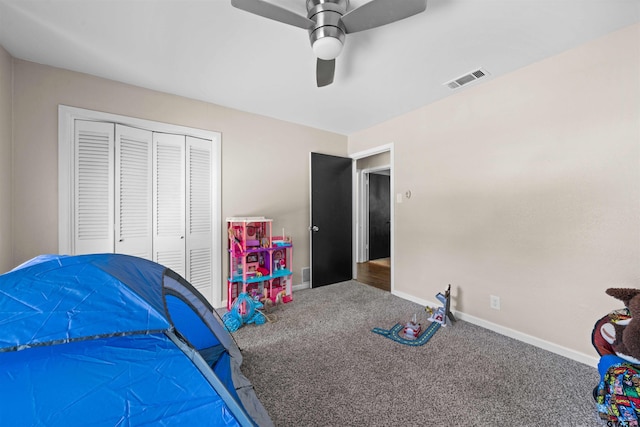 carpeted bedroom with ceiling fan and a closet