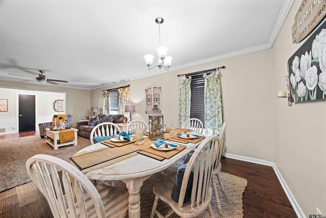 dining room featuring dark hardwood / wood-style floors, ceiling fan with notable chandelier, and crown molding