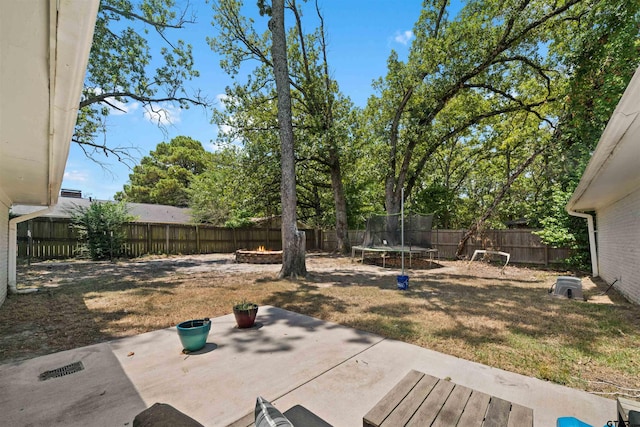 view of yard featuring a trampoline and a patio area