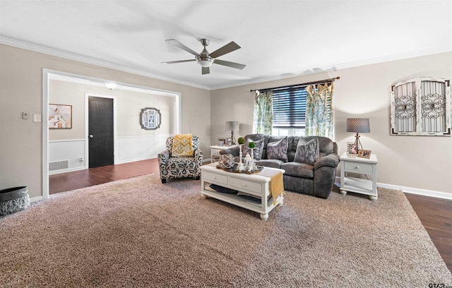 living room featuring dark hardwood / wood-style floors, crown molding, and ceiling fan