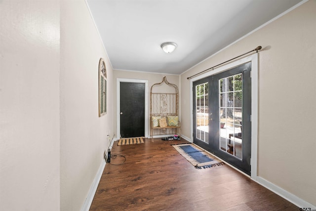 doorway featuring dark hardwood / wood-style floors, french doors, and ornamental molding