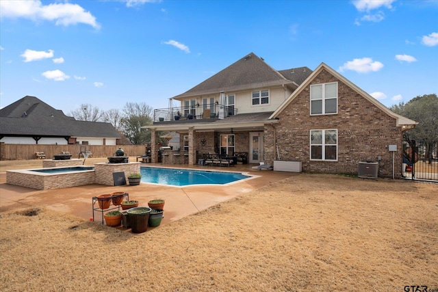 view of swimming pool with a patio, central air condition unit, and an in ground hot tub