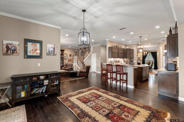 interior space featuring dark hardwood / wood-style flooring, ornamental molding, and an inviting chandelier