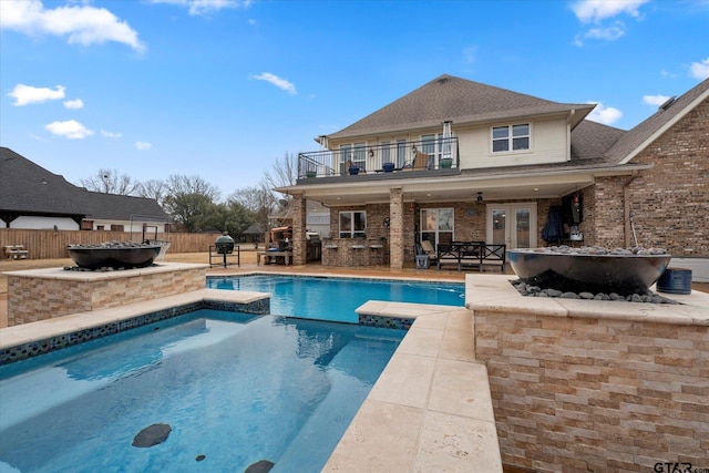 view of pool featuring a patio, a bar, and french doors