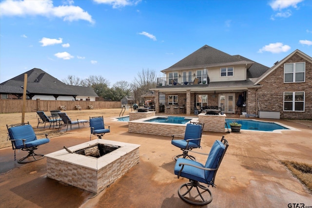 view of swimming pool with a jacuzzi, a patio area, and a fire pit