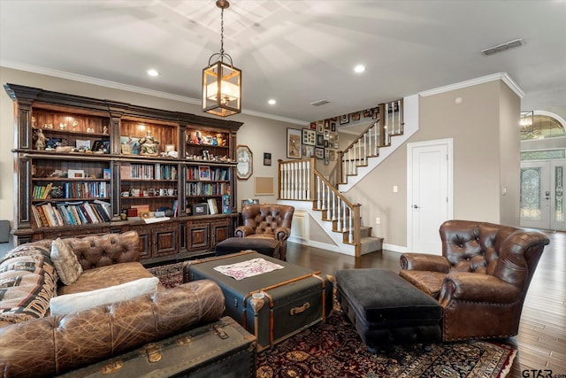 living room featuring hardwood / wood-style floors and crown molding