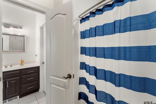 bathroom featuring tile patterned floors, vanity, and walk in shower