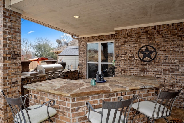 view of patio / terrace with an outdoor kitchen, a grill, and sink