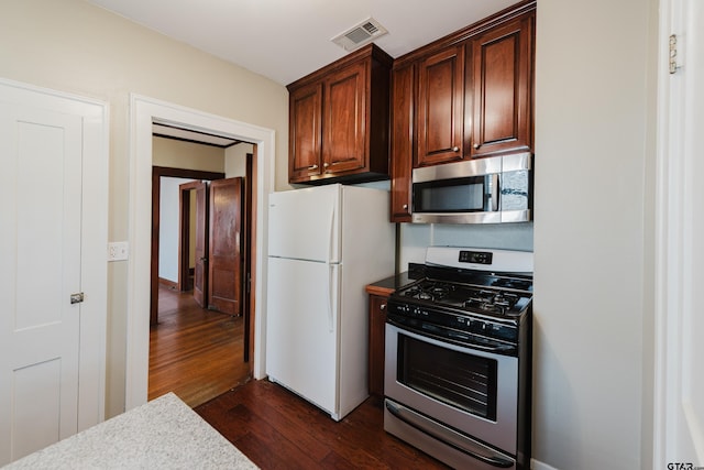 kitchen with visible vents, appliances with stainless steel finishes, and dark wood-type flooring