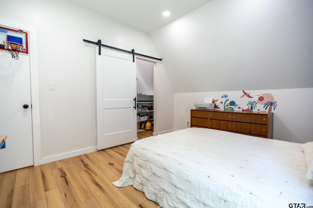 15683 Crk 472, Tyler, TX 75706 - bedroom featuring a barn door, wood finished floors, lofted ceiling, and recessed lighting