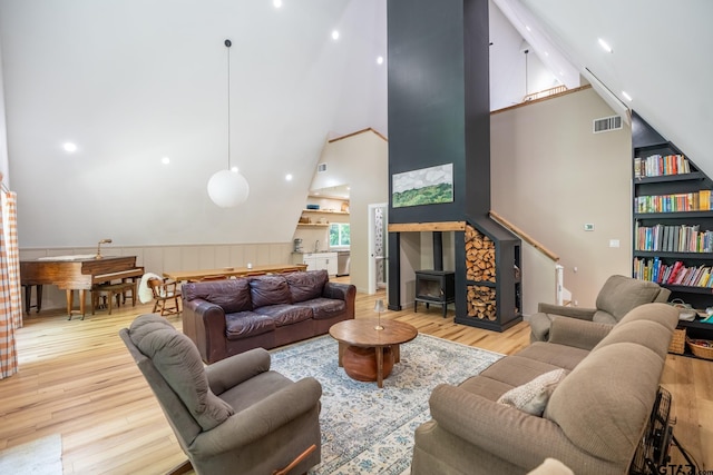15683 Crk 472, Tyler, TX 75706 - living area with wood finished floors, high vaulted ceiling, a wood stove, and recessed lighting