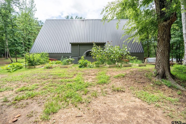 15683 Crk 472, Tyler, TX 75706 - view of home's exterior with a metal roof, a vegetable garden, and an outbuilding