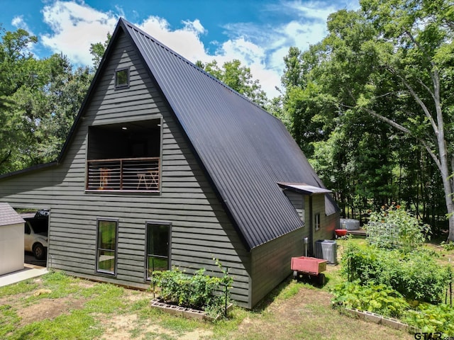 15683 Crk 472, Tyler, TX 75706 - view of home's exterior featuring a metal roof and a vegetable garden