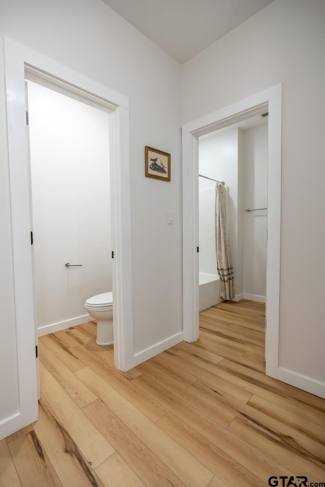 15683 Crk 472, Tyler, TX 75706 - hallway featuring light wood-type flooring and baseboards