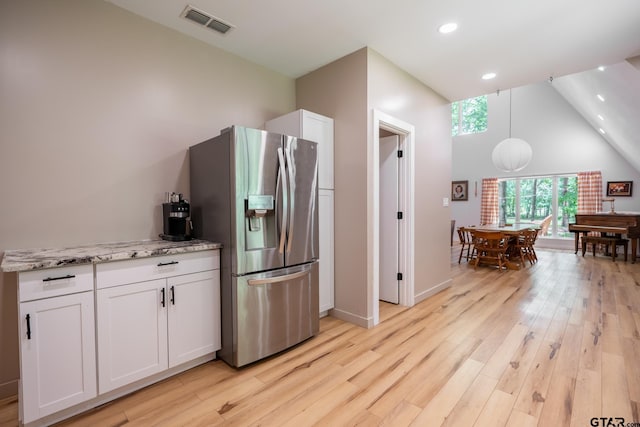 15683 Crk 472, Tyler, TX 75706 - kitchen with stainless steel fridge, white cabinets, light wood-type flooring, recessed lighting, and light stone counters