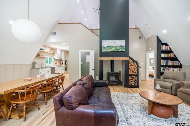 15683 Crk 472, Tyler, TX 75706 - living area with a wood stove, light wood finished floors, and high vaulted ceiling
